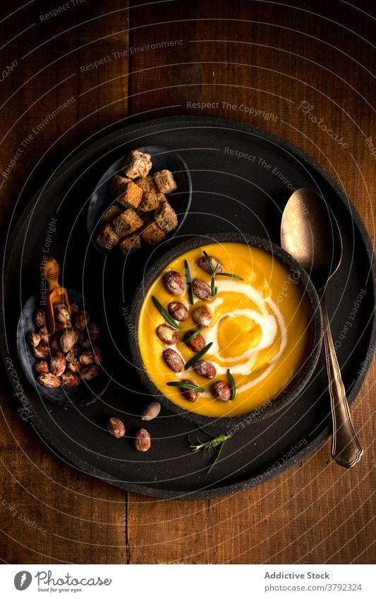 Appetizing pumpkin cream soup in bowl on table dish serve lunch bread crouton healthy food vegetarian wooden meal delicious organic gourmet vegetable cuisine