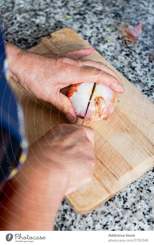 Woman peeling onion on chopping board cook cut prepare food kitchen ingredient process culinary housewife woman recipe dish hand homemade vegetable female