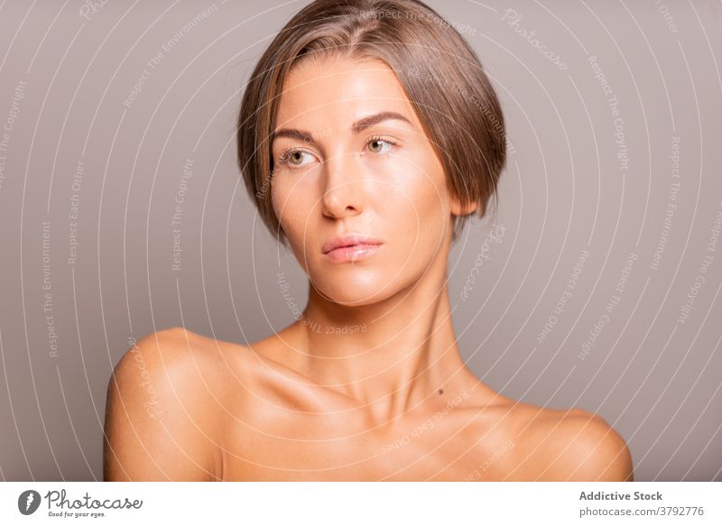 Woman with short hair in studio model woman style tender appearance trendy charming female beauty sensual happy vogue individuality perfect bare shoulders