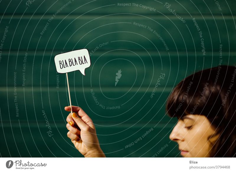Young woman with closed eyes holds a speech bubble with "Bla Bla Bla Bla" written on it. talk bore communication Lecture tired babble Absurdity Boredom To talk