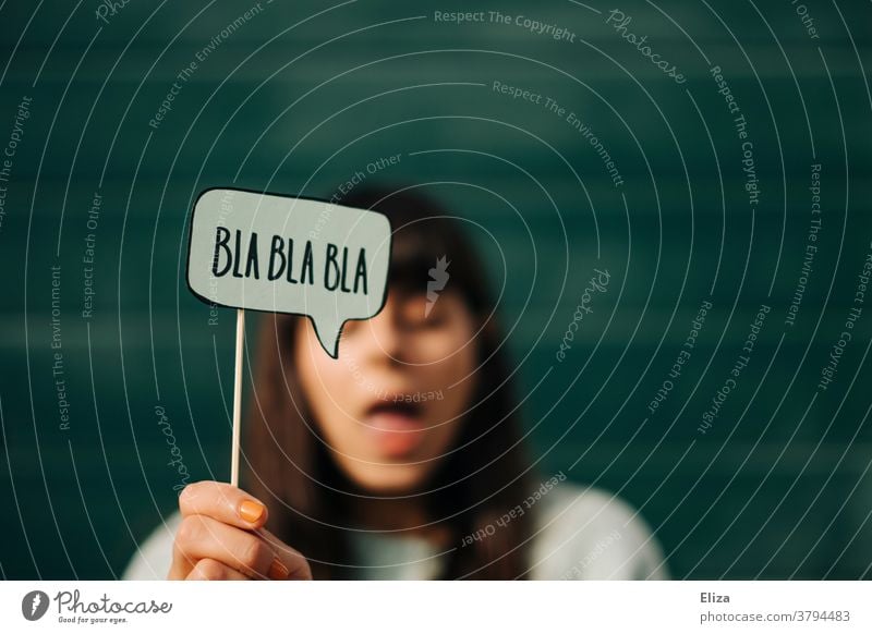 A speaking woman holds a speech bubble in which "Blah-blah" is written. Lecture, monologue, boring. blablabla Monologue Communicate babble boringly