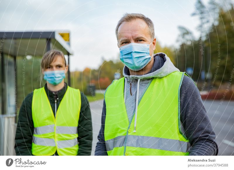 Coronavirus garbage. Volunteers collecting used disposable medical masks and gloves near the bus stop and along the highway. The problem of environmental pollution during a pandemic COVID-19