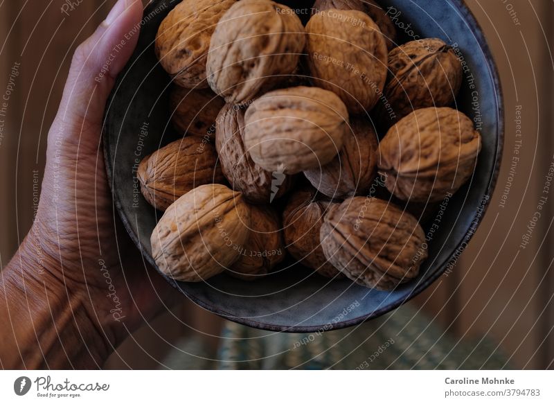 Woman holding a bowl of walnuts Walnuts Food Delicious Colour photo Nutrition Healthy Vegetarian diet Organic produce Deserted Healthy Eating Fruit Fresh Day