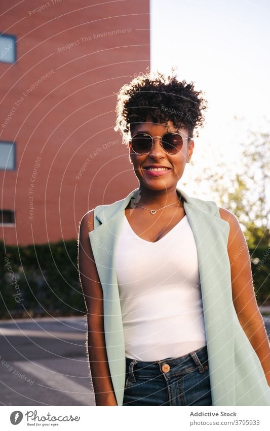Happy ethnic woman in trendy outfit and sunglasses style fashion urban happy summer afro smile cheerful young female african american black positive casual