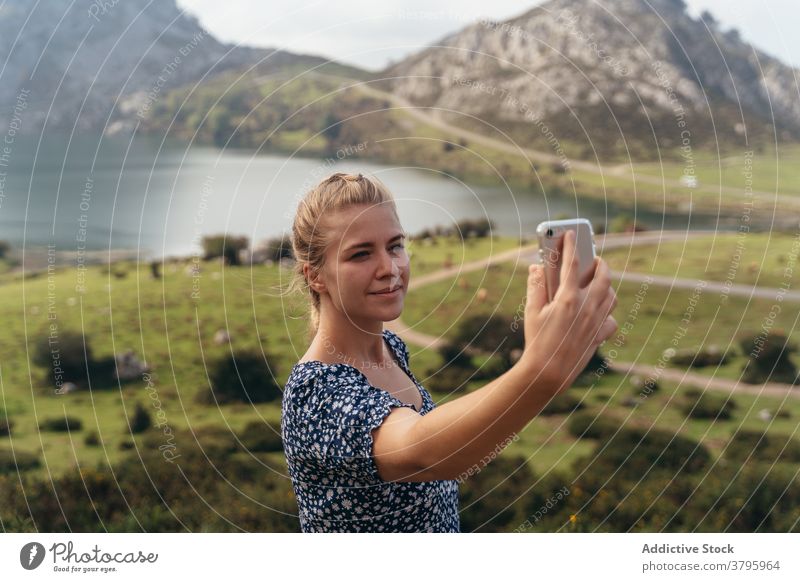 Woman taking selfie with spectacular mountains valley on background woman highland take photo smartphone amazing landscape memory moment environment picturesque