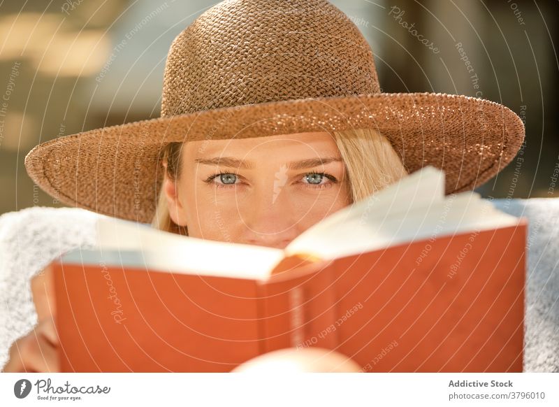 Female tourist reading book while resting on deckchair woman chill beautiful travel happy holiday female relax resort lounge break vacation weekend summer