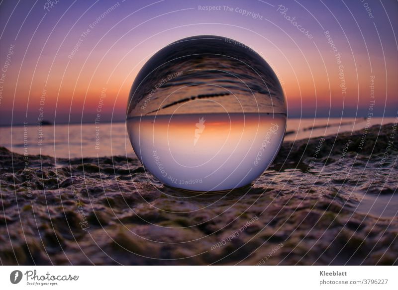 Glass ball on a rock plate, which reflects the beautiful water and light of the lake at sunset Sunset Exterior shot Sphere Light Reflection intensely coloured