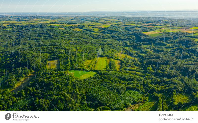 Aerial view of over green landscape Above Across Arable Bush Canopy Country Cultivated Cultivation Deciduous Drone Ecosystem Environment Farmland Field Flora