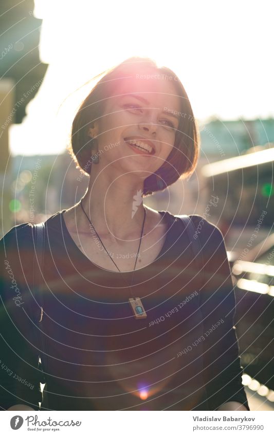 Girl laughs in a back light outdoors Cozy calm Easy Hair Lady Beautiful Colour photo Beautiful weather Shallow depth of field Summer Blur Light Day Lens flare