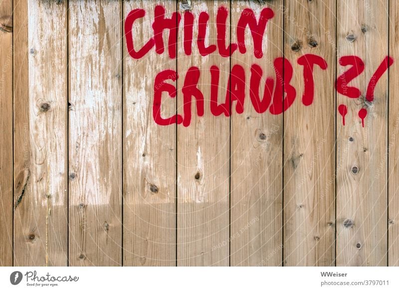Can't I have a little chill? Fence slats boards writing Graffiti Red words question allowed one may Permission interdiction Limitation Party ban curfew