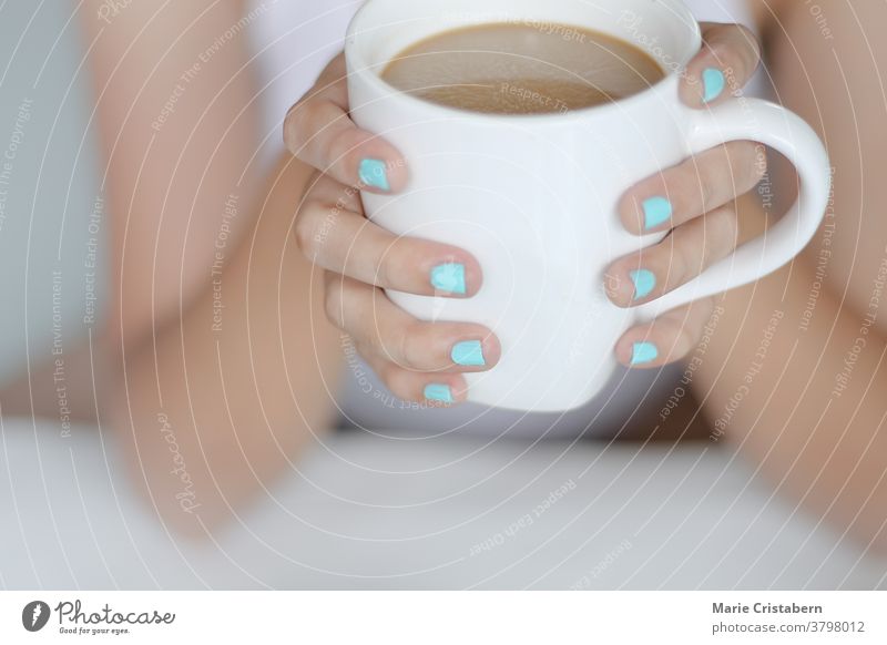 Hands with blue nail color holding a cup of coffee, candid peaceful morning routine hands lifestyle daily life calm relaxing warmth comfort cozy hygge