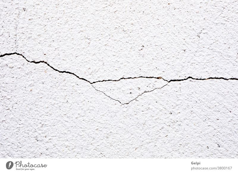 Close-up of a cracked background abstract old concrete wall paint pattern texture grunge white cement rough dirty design surface backdrop construction