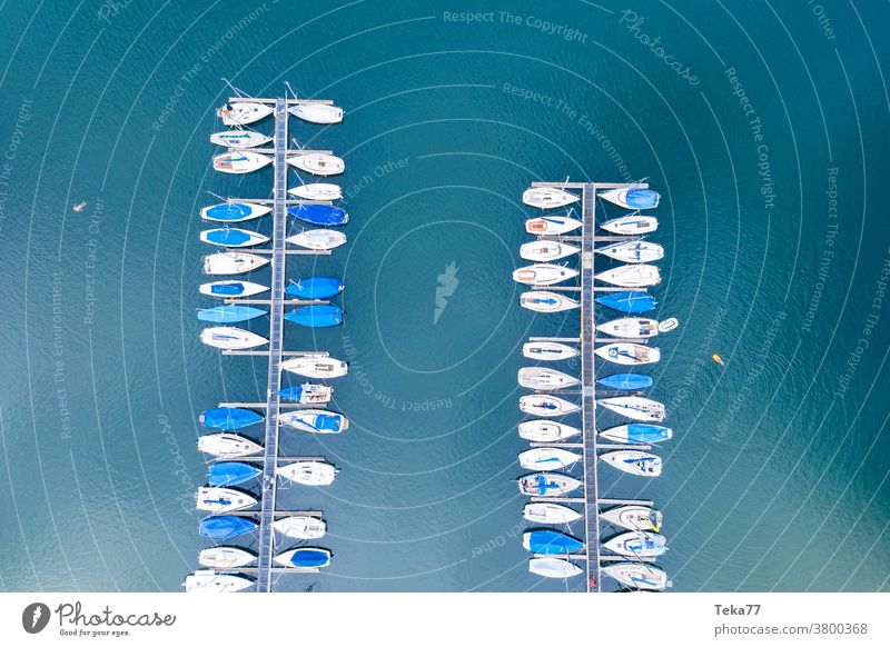 a sports harbor from above sport boat harbor sailing ships boats from above water white waves water sports swimming