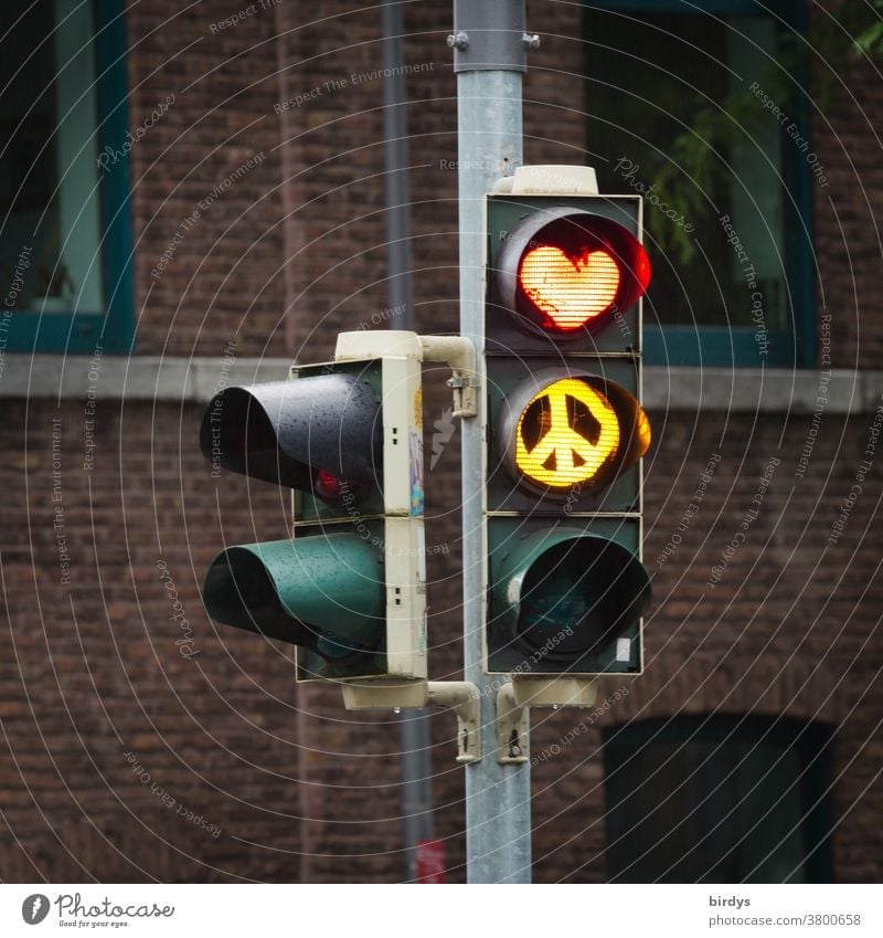 Love and peace, traffic light with red heart and yellow peace sign. Love and peace Heart Peace Traffic light Red Yellow Creativity Road safety symbolism symbols