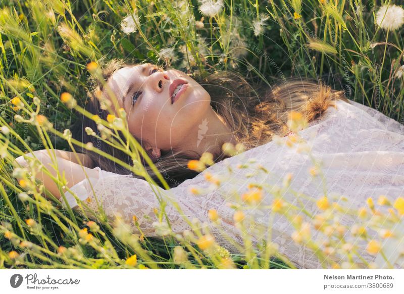 Portrait of a cute caucasian woman lying on the grass. blonde girl beautiful natural light flowers plants pretty Woman Human being Nature Natural Summer