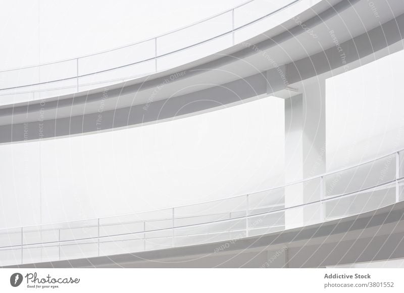 White curvy ramps outside futuristic building incline way route architecture construction geometry white structure contemporary smooth exterior modern sunlight