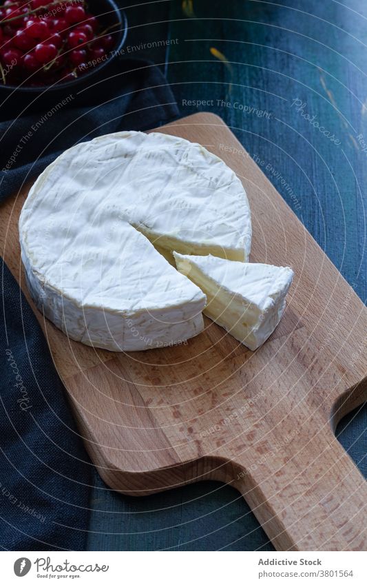 Truckle of Camembert cheese on wooden board camembert truckle organic tasty food dairy composition fresh wheel slice appetizing soft portion prepare lumber