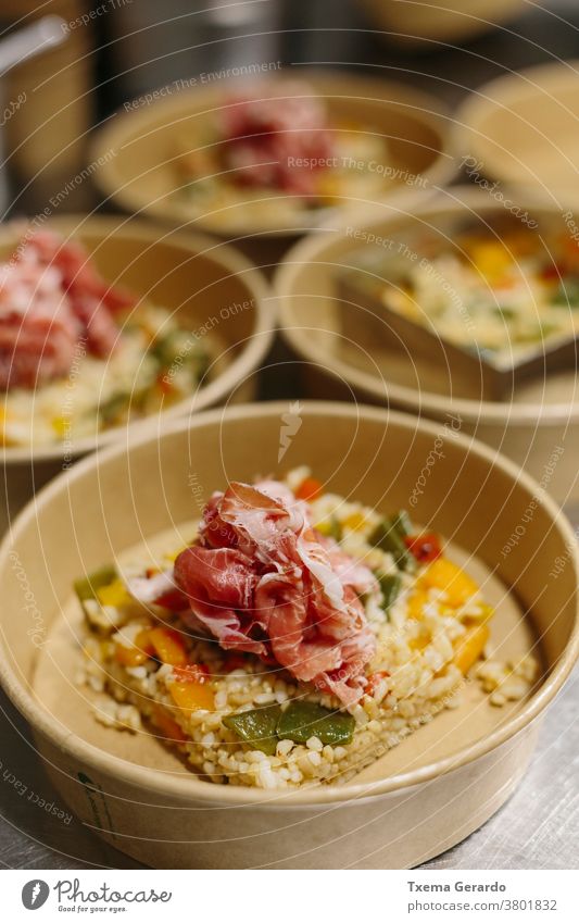 Preparing a ham salad with rice to take away. The containers used are compostable. takeaway food organic gourmet tomatoes kitchen restaurant chef vegetable