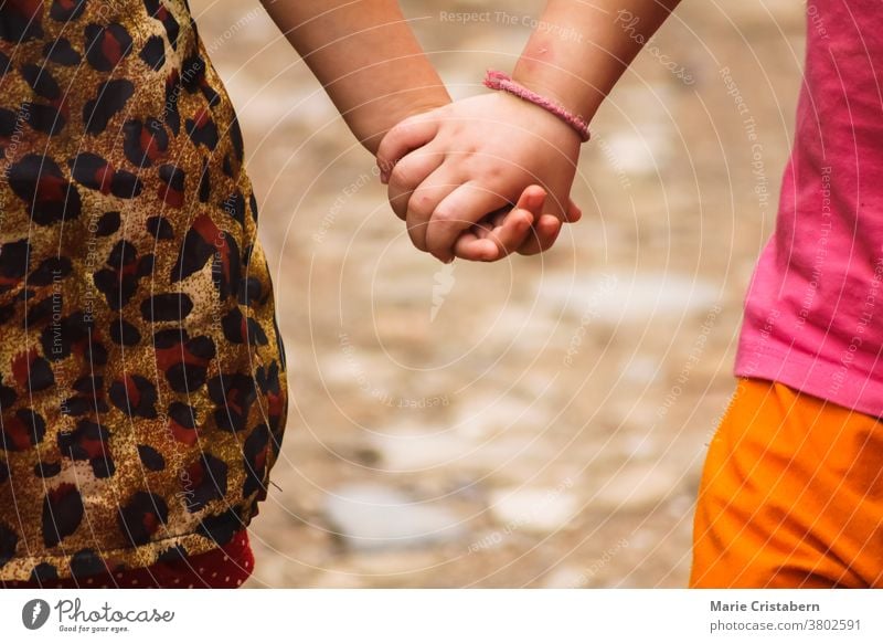 Close up of kids holding hands day childcare symbol hold hands friends joy unity innocence summertime safety beautiful happiness diversity caucasian brown skin