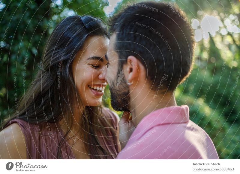 Loving ethnic couple in sunny park in love sensual eyes closed relationship passion lover amorous temptation affection fondness amour tender valentine partner