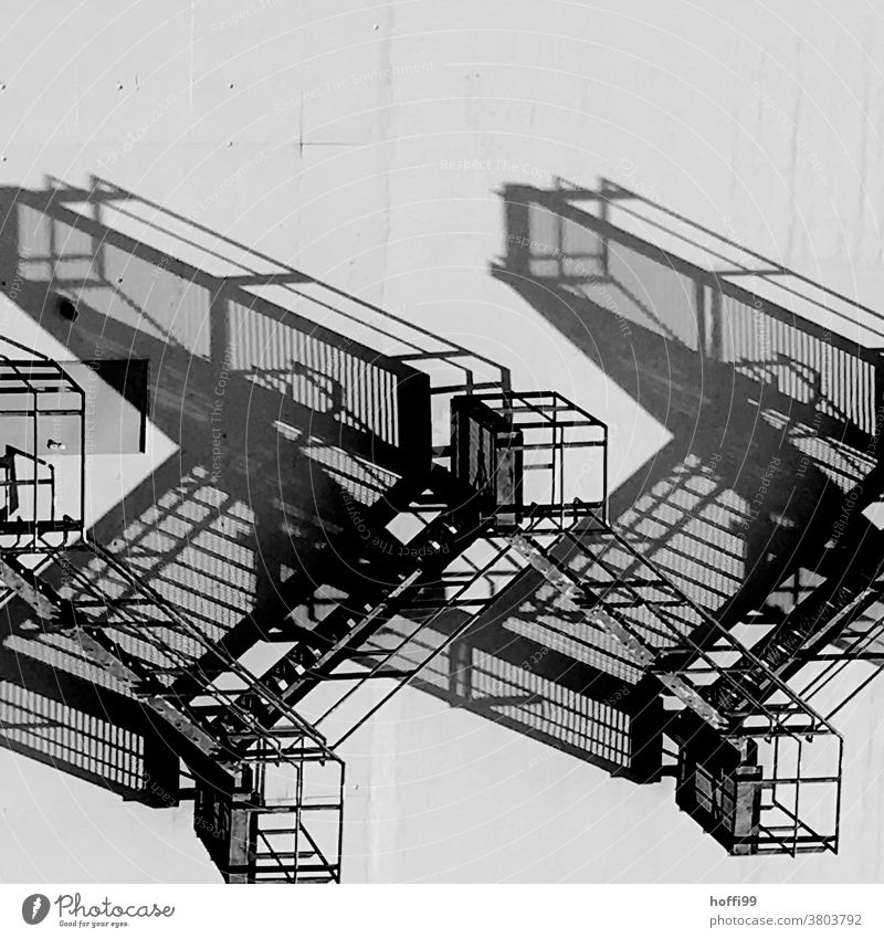 surreal shadow play of an emergency staircase Shadow play Abstract Light Stairs External Staircase Escape route Architecture Banister Structures and shapes