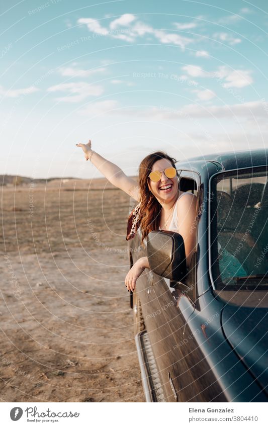 Young traveler woman having fun with the guitar in the jeep 4x4 car making a wanderlust vacation at sunset female trip people young vintage beautiful lifestyle