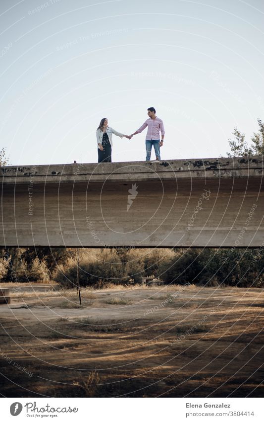young couple in love holding hands on an old bridge sunset antique ruins kiss kissing view together river tourism tourist sunshine romantic architecture