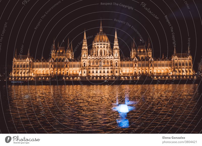 views of the budapest parliament from the danube river at night, hungary built sunset architecture destination traditional street monument symbol illuminated