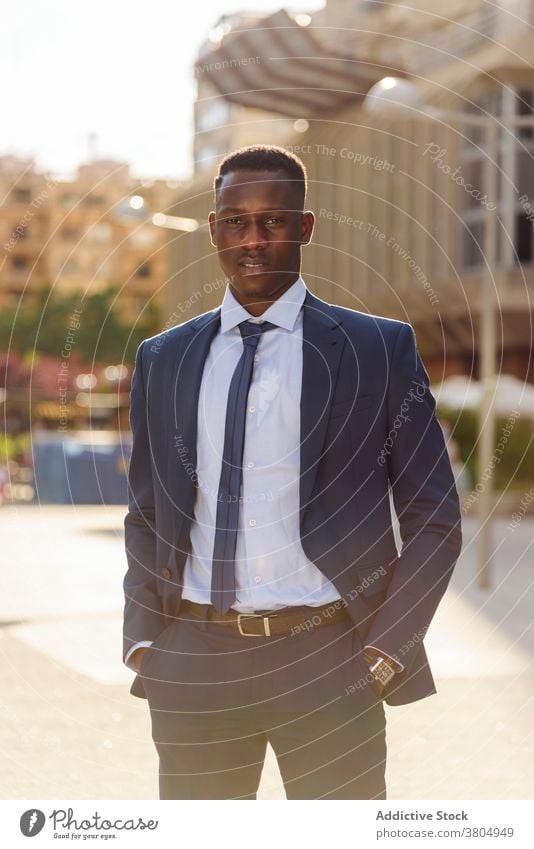 Black businessman in formal suit standing in city confident urban modern elegant executive success manager professional adult male entrepreneur african american