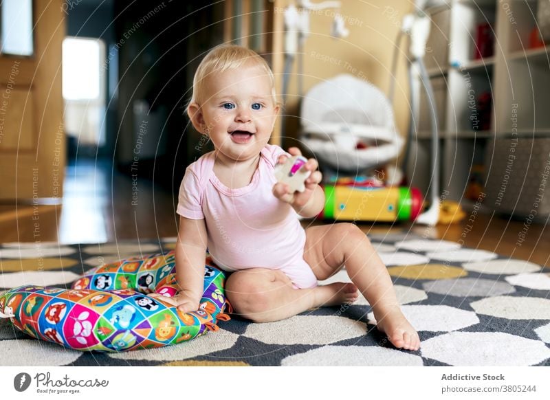 baby girl playing on floor home happy having fun toy grimace love daughter together adorable young child toddler motherhood cute joy bonding relationship enjoy