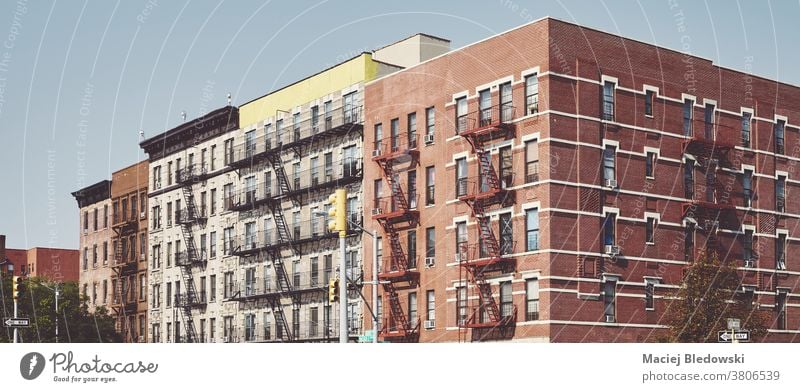 Buildings with fire escapes in Harlem New York, USA. city building old house retro home urban residential NYC manhattan panorama outdoors architecture filtered