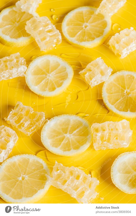Honeycombs with fresh lemon slices on yellow background honeycomb sweet tasty citrus fruit drip colorful treat yummy bright ornament delicious similar decor