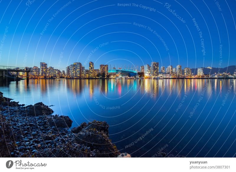 night view of city skyline canada travel architecture vancouver urban tourism cityscape modern downtown skyscraper water reflection harbor bay evening landmark