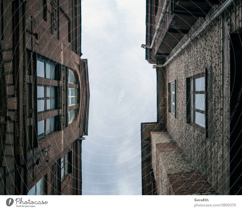 old vintage brick houses on a city street in Ukraine abandoned architecture blue bottom view building cityscape clouds color conflict crisis day donetsk europe