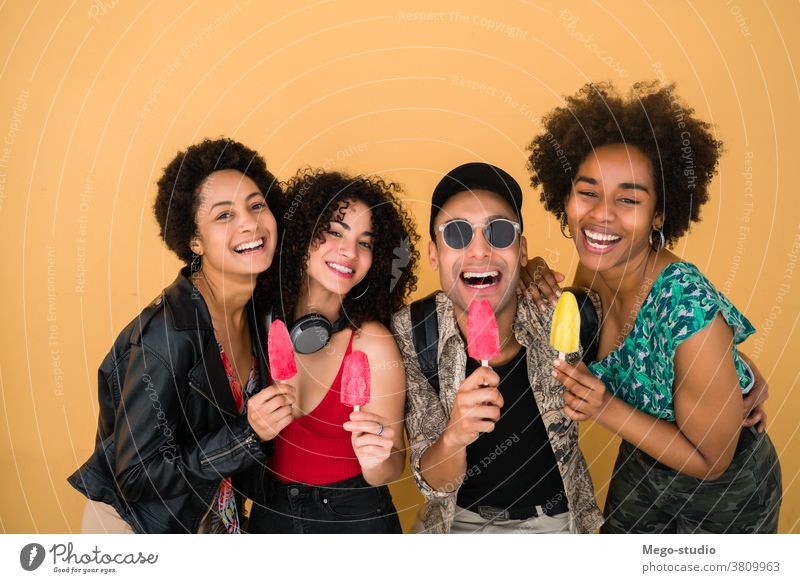 Multi-ethnic group of friends enjoying summertime while eating ice cream. multiethnic friendship young people dessert diversity diverse pleasure man woman