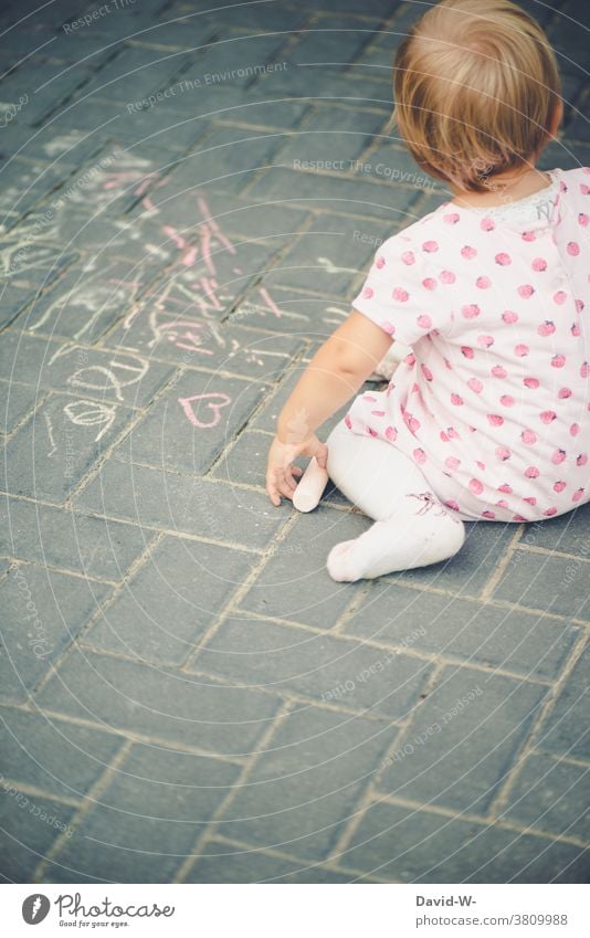 Child paints with chalk on the floor Chalk Painting (action, artwork) Creativity Girl street-painting chalk Employment Infancy fun