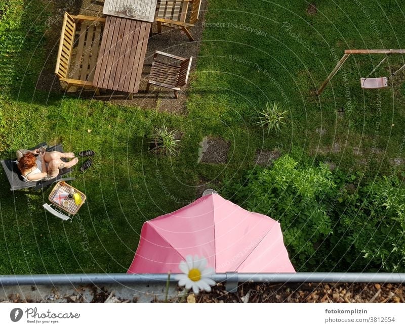 View from above into a garden with a woman taking a break Garden Woman recover Break chill take a break Calm free time leisure Relaxation tranquillity Sit Day