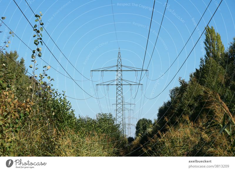 overhead power cable or transmission line high-voltage power line tower pole electricity pylon utility high-tension conductor nature energy sky industry