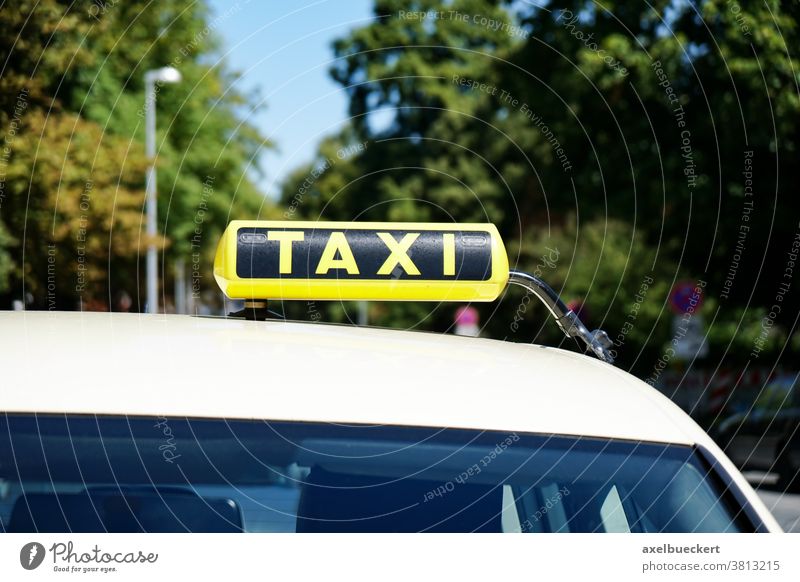 german taxi sign on car roof cab yellow taxi stand taxicab closeup close-up urban traffic city street transport transportation travel copy space copyspace