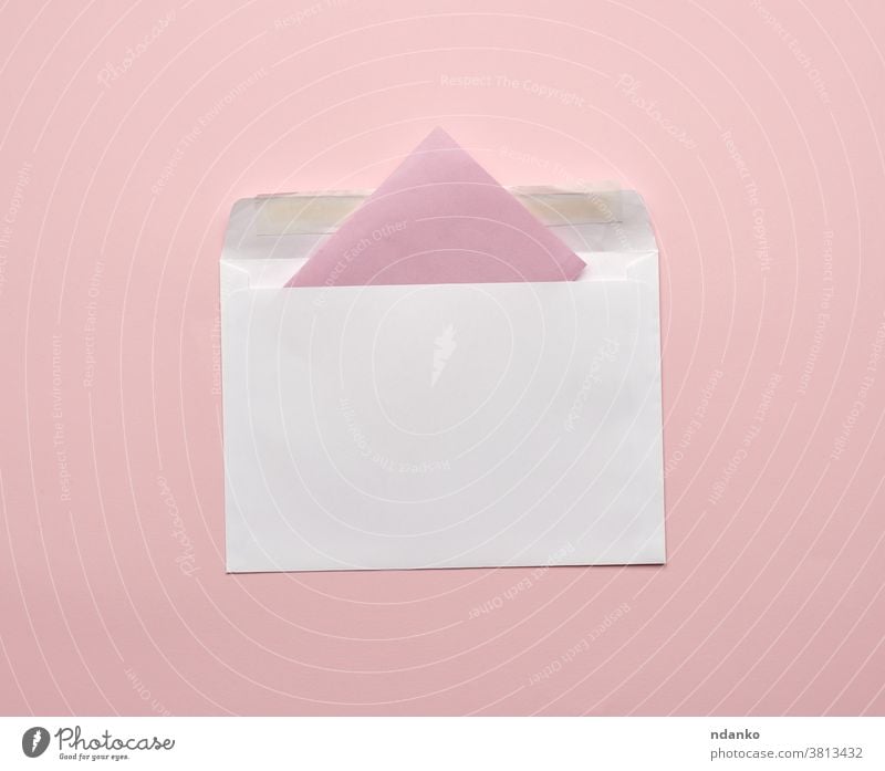 white envelope on a pink background empty information invitation letter mail message note open page paper postcard stationery studio template top blank closeup