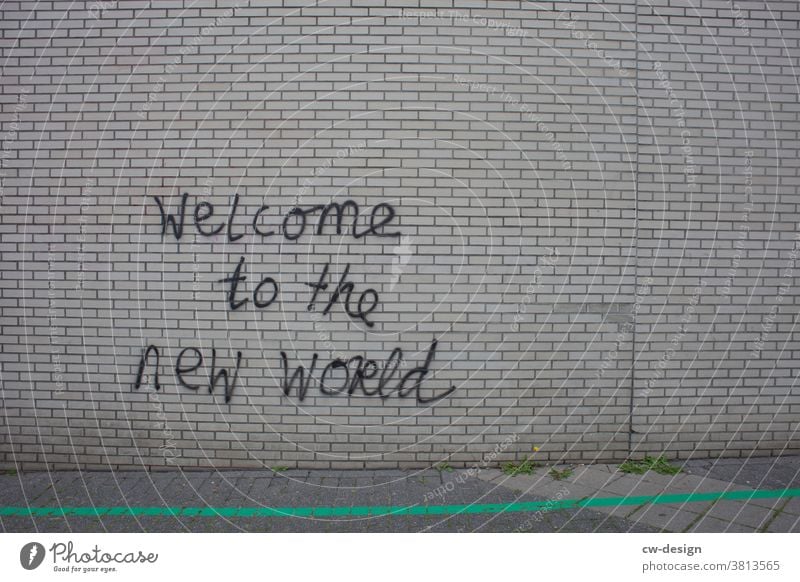 Graffiti on clinker wall "Welcome to the new World". clinker facade Daub Wall (building) Facade Characters Youth culture Trashy Subculture Street art