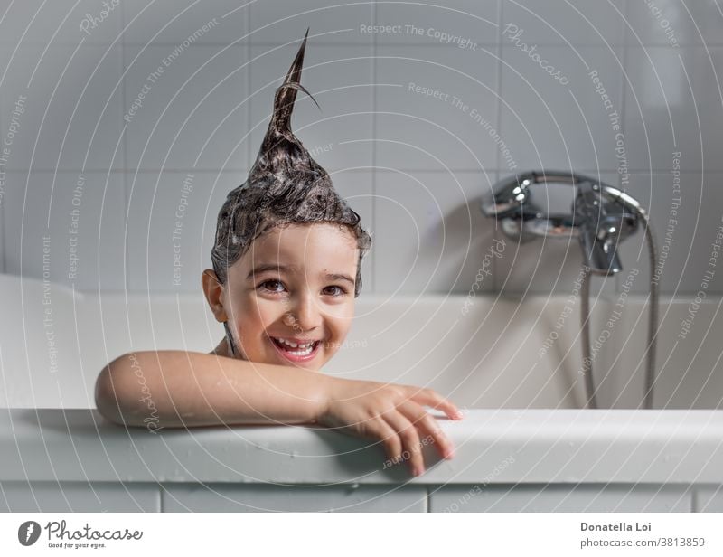 Smiling child in the bathtub adorable beautiful body care caucasian childhood clean cute face foam fun hair happy hygiene infant kid laughing lifestyle one