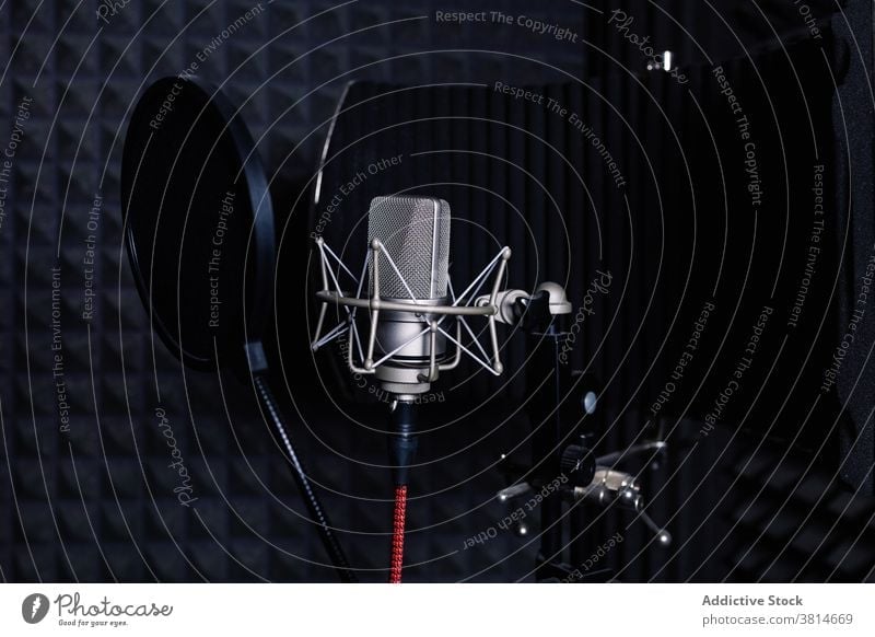 Modern microphone in dark studio record music soundproof foam equipment modern audio professional gadget song melody electronic device metal wire broadcast