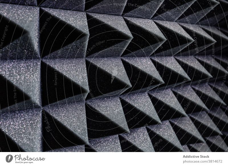 Textured background of soundproof foam pattern texture geometry three dimensional shape soft record studio wall pyramid black structure surface design material