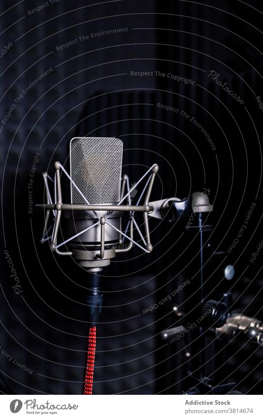 Modern microphone in dark studio record music soundproof foam equipment modern audio professional gadget song melody electronic device metal wire broadcast