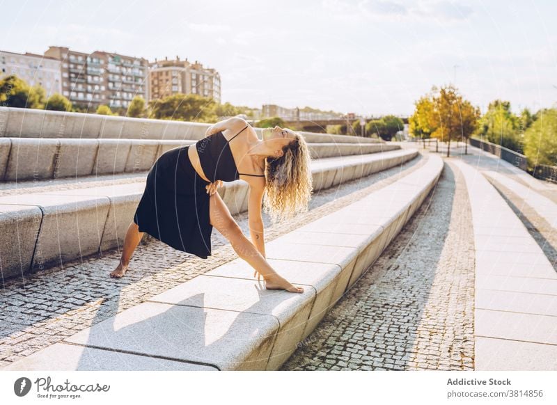 Slim woman practicing yoga in lateral bend position asana triangle trikonasana stretch flexible pose practice balance zen focus female wellness concentrate