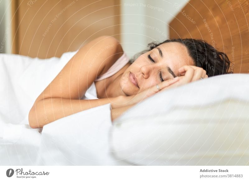 Gentle woman sleeping in bedroom at home comfort soft pillow blanket calm dream female pajama lying cozy peaceful relax quiet eyes closed tranquil nap serene