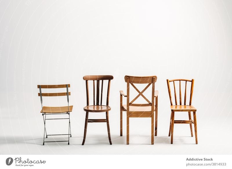 Four classical wooden chairs against white background furniture seat old-fashioned hipster minimal simplicity copy space objects absence manufactured object