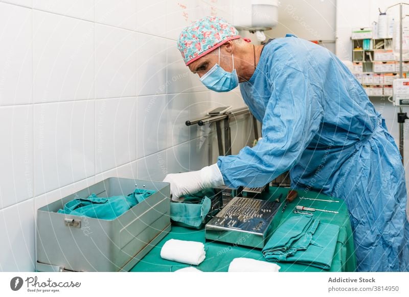 Veterinarian surgeon preparing tools for surgery before operation on a dog veterinarian mask equipment clinic doctor hospital pet operating room sterile theater