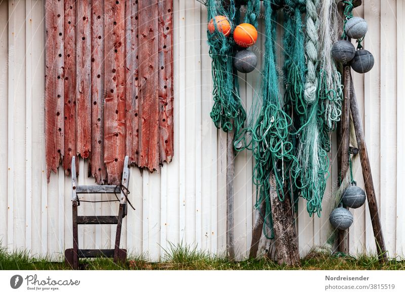 Maritime still life on a house wall in Norway Wall (building) nets Fishing net Buoy Wood board Cart sack truck leash rope rope Lashings Harbour Wooden house